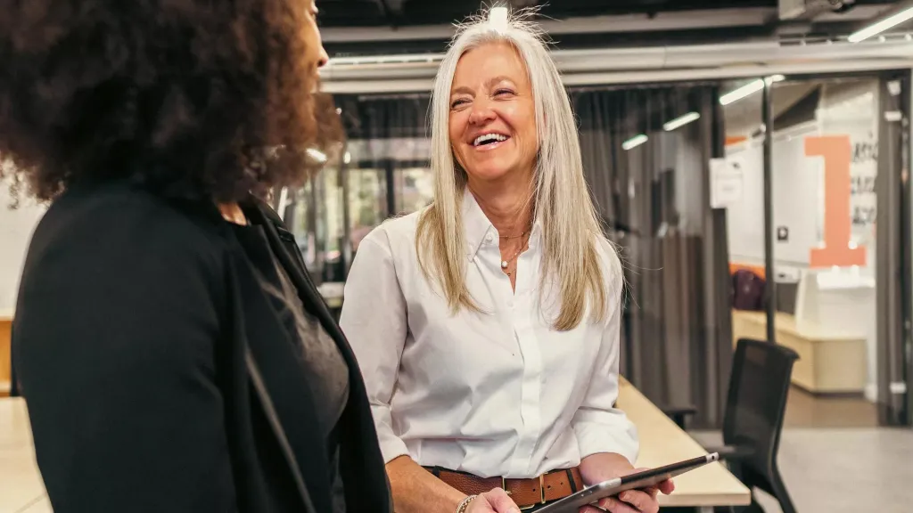 Female boss with tablet talking to employee